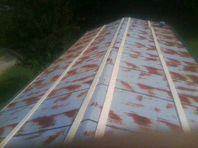 Rusted metal roof panels with new wood purlins before replacement — Storm Damage Roof Repair in El Cajon by Roofing Brothers