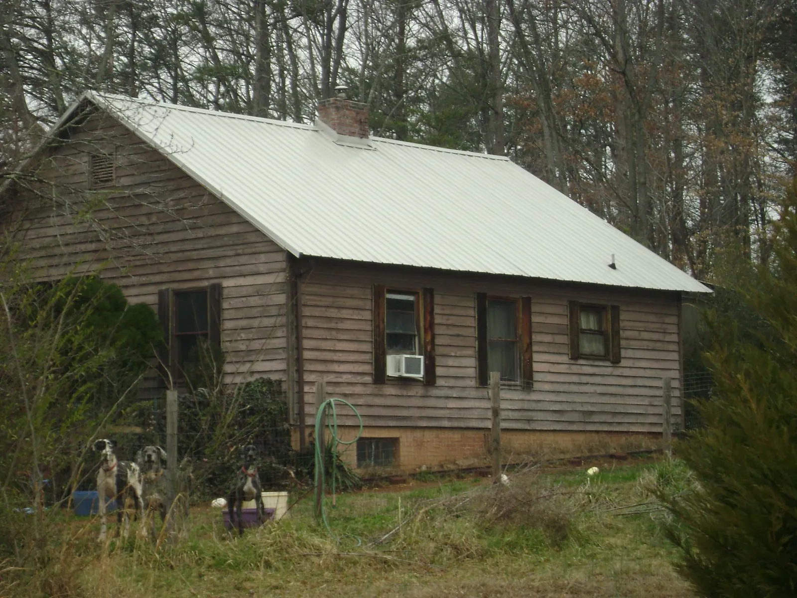 White metal roof on an old wood sided farmhouse, from a Metal Roof Installation job in El Cajon